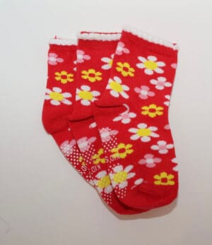 Three red daisy-patterned children's socks