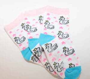 White socks with swans, pink stars, blue toes